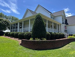 Well maintained lawn and shrubs in front of a home